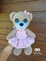 Teddy girl in a pink dress. Named toy